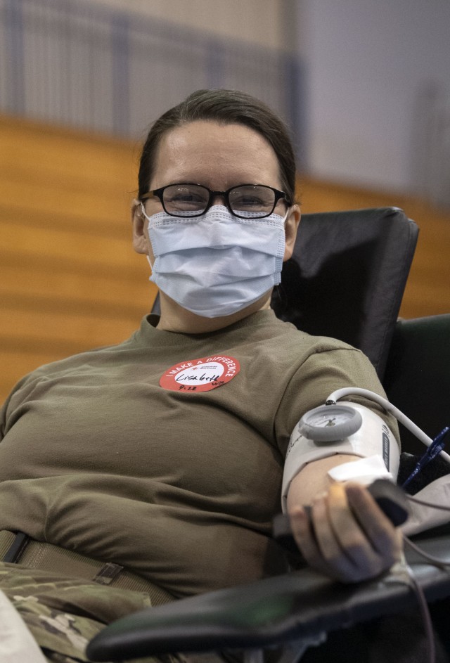 Lt. Col. Lisabeth Bush, deputy commander of clinical services at Moncrief Army Hospital Clinic, donates blood during the Community Blood Drive Aug. 25 in the Solomon Center. Bush said she is determined to give 40 units of blood to make up 40 units...