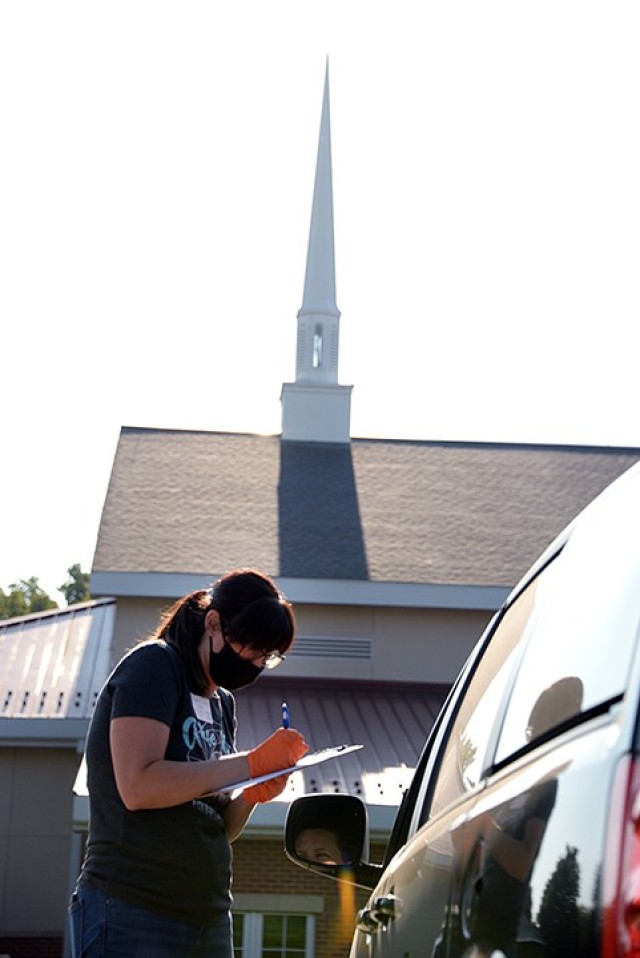 Crystal Lewis, prayer coordinator for Protestant Women of the Chapel, registers Tamerra Rodriguez for PWOC so she can receive Zoom links to upcoming meetings during the PWOC drive-in fall kickoff Aug. 25. PWOC members listened to the kick-off...