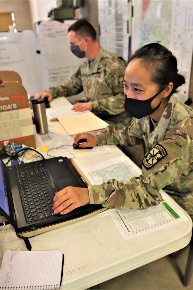 Maj. Dan Bartlett and Capt. Hyeon Kim, both who served as operations officers with ROTC training at Fort McCoy in early August 2020, plan some training Aug. 13, 2020, in a building at the Combined Arms Collective Training Facility on South Post at...