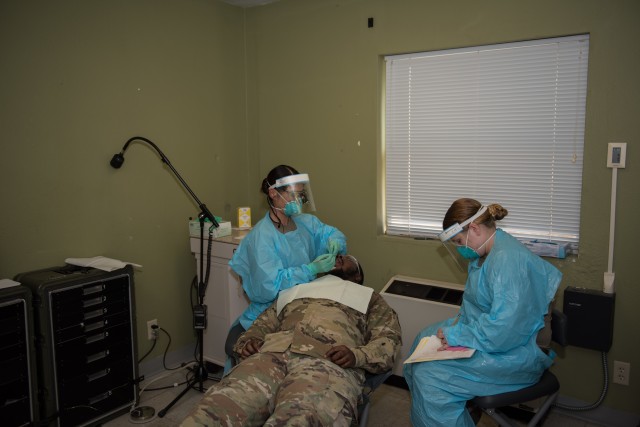 Maj. Jenna Nakanishi, dental corps officer, and dental specialist, Spc. Breanna Ellis, the 502nd Dental Company Area Support (DCAS), conduct dental operations at the Dental Clinic Simulation Center.  Dental specialists from the 502nd DCAS participated in a validation exercise Aug. 17-20. (U.S. Army photo by Sgt. 1st Class Kelvin Ringold)