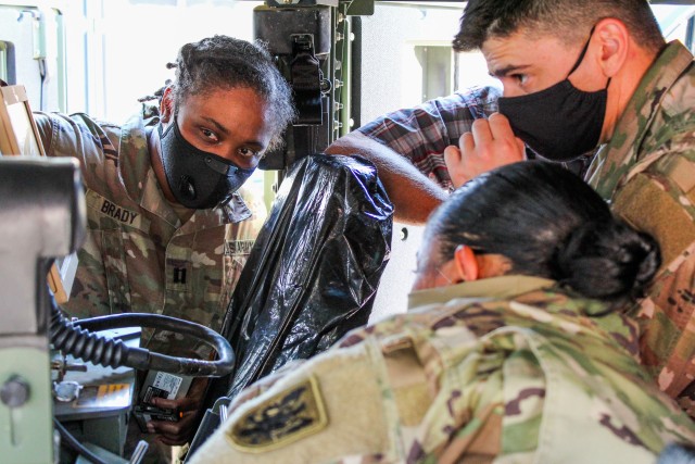 U.S. Army Reserve Capt. Jha'Nae F. Brady,  the network operations officer for the 11th Expeditionary Combat Aviation Brigade, instructs Soldiers on how to properly install and operate the Blue Force Tracker during phase two of Operation Crossbow at Fort Carson, Colo., Aug. 6, 2020.  The BFT facilitated convoy operations after being tested during a Communications Exercise to establish effective connections across the brigade.
