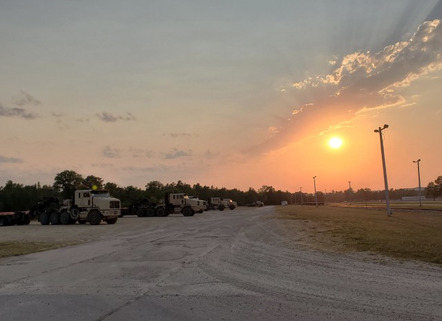 Military vehicles assigned to the 1158th Transportation Company of the Wisconsin National Guard are shown at sunset Aug. 26, 2020, at Fort McCoy, Wis. On Aug. 25, Soldiers with the 1158th unloaded 22 railcars at the installation's rail yard on...