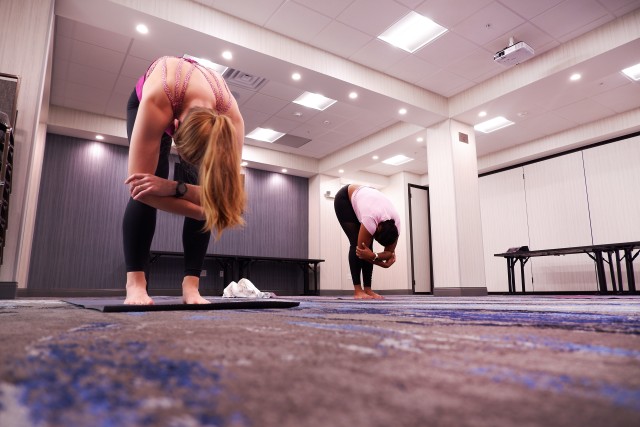 U.S. Air Force Capt. Bridget Caulkins, left, and U.S. Air Force Master Sgt. Deloran Lomax, both members of COVID Theater Hospital-1, Travis Air Force Base, Calif., participate in a yoga class provided by a U.S. Air Force behavioral health team...
