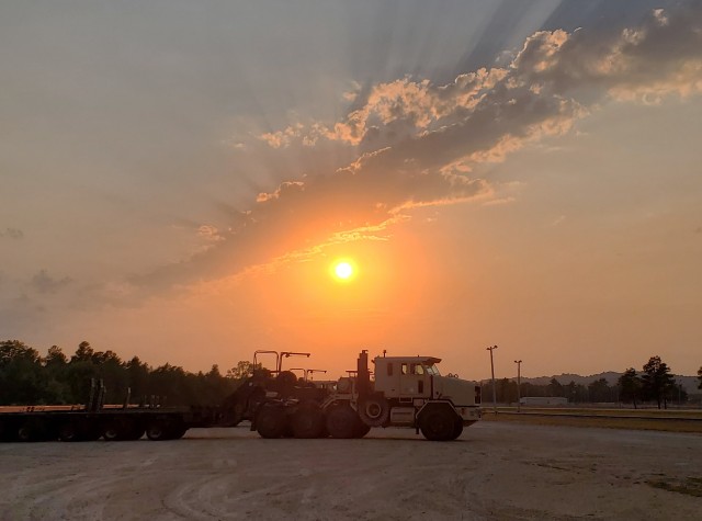 Military vehicles assigned to the 1158th Transportation Company of the Wisconsin National Guard are shown at sunset Aug. 26, 2020, at Fort McCoy, Wis. On Aug. 25, Soldiers with the 1158th unloaded 22 railcars at the installation's rail yard on...