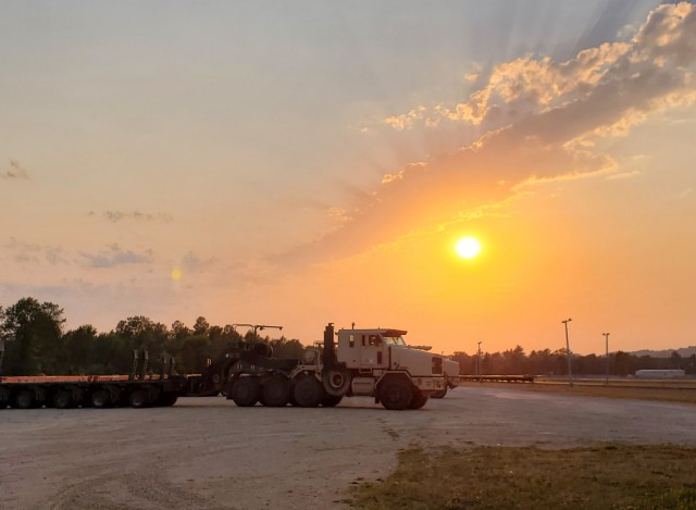 Military vehicles assigned to the 1158th Transportation Company of the Wisconsin National Guard are shown at sunset Aug. 26, 2020, at Fort McCoy, Wis. On Aug. 25, Soldiers with the 1158th unloaded 22 railcars at the installation's rail yard on...