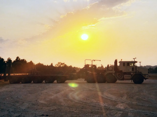 Military vehicles assigned to the 1158th Transportation Company of the Wisconsin National Guard are shown at sunset Aug. 26, 2020, at Fort McCoy, Wis. On Aug. 25, Soldiers with the 1158th unloaded 22 railcars at the installation's rail yard on...