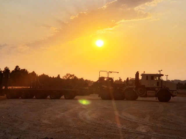 Military vehicles assigned to the 1158th Transportation Company of the Wisconsin National Guard are shown at sunset Aug. 26, 2020, at Fort McCoy, Wis. On Aug. 25, Soldiers with the 1158th unloaded 22 railcars at the installation's rail yard on...