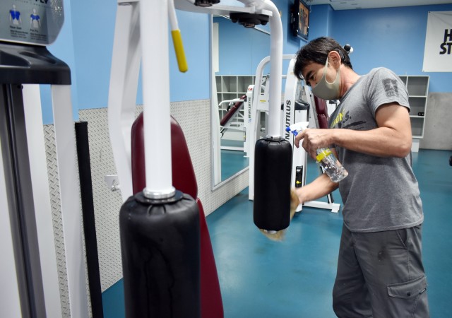 Hiroto “ET” Mizukabo cleans a machine in the weight room at the Yano Fitness Center at Camp Zama, Japan, Aug. 27.