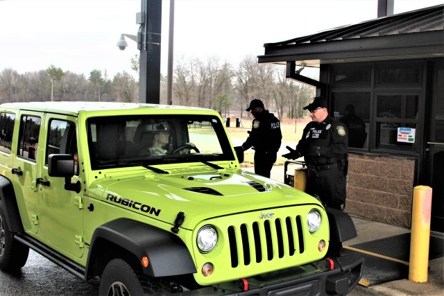Police officers with the Directorate of Emergency Services Police Department check identification cards April 3, 2020, at the Main Gate at Fort McCoy, Wis. At that time, it was still early in the installation’s response to the national COVID-19...
