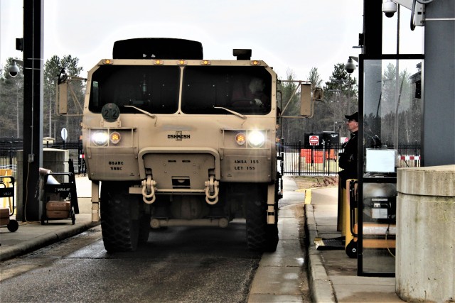 Police officers with the Directorate of Emergency Services Police Department check identification cards April 3, 2020, at the Main Gate at Fort McCoy, Wis. At that time, it was still early in the installation’s response to the national COVID-19...