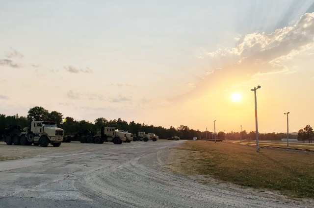 Military vehicles assigned to the 1158th Transportation Company of the Wisconsin National Guard are shown at sunset Aug. 26, 2020, at Fort McCoy, Wis. On Aug. 25, Soldiers with the 1158th unloaded 22 railcars at the installation's rail yard on...