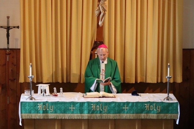 Bishop Richard Spencer of the Archdioceses of Military Services reads a homily during a Catholic Mass on July 19 at Fort McCoy. Spencer visited the Fort McCoy RSO to meet and talk with leadership about the religious community and services offered...