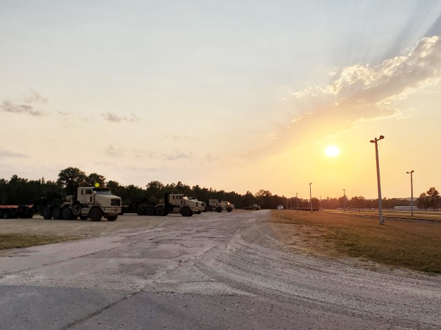 Military vehicles assigned to the 1158th Transportation Company of the Wisconsin National Guard are shown at sunset Aug. 26, 2020, at Fort McCoy, Wis. On Aug. 25, Soldiers with the 1158th unloaded 22 railcars at the installation's rail yard on...