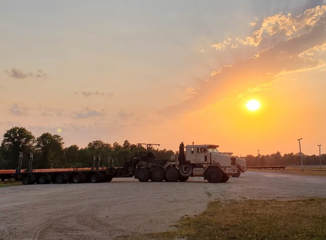 Military vehicles assigned to the 1158th Transportation Company of the Wisconsin National Guard are shown at sunset Aug. 26, 2020, at Fort McCoy, Wis. On Aug. 25, Soldiers with the 1158th unloaded 22 railcars at the installation's rail yard on...