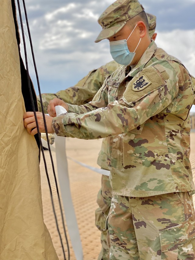 Spc. Min Park, a U.S. Army Reserve supply specialist with Headquarters and Headquarters Company, 11th Expeditionary Combat Aviation Brigade, completes the set up of a tent outside the Mission Training Complex in preparation of phase three of Operation Crossbow, a home-station command post-exercise on Fort Carson, Colo.,  Aug. 10, 2020.