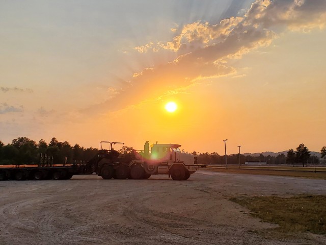 Military vehicles assigned to the 1158th Transportation Company of the Wisconsin National Guard are shown at sunset Aug. 26, 2020, at Fort McCoy, Wis. On Aug. 25, Soldiers with the 1158th unloaded 22 railcars at the installation's rail yard on...