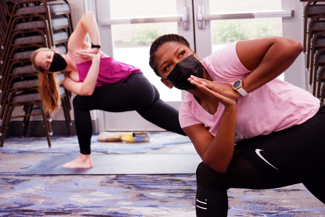U.S. Air Force Maj. Bridget Caulkins, left, and U.S. Air Force Master Sgt. Deloran Lomax, both members of COVID Theater Hospital-1, Travis Air Force Base, Calif., participate in a yoga class provided by a U.S. Air Force behavioral health team...
