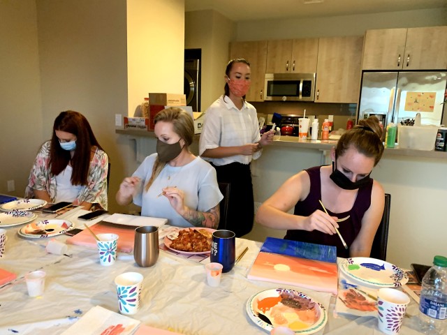 U.S. Air Force Tech. Sgt. Susan Kicker, center, a mental health technician and member of a behavioral health team assigned to support COVID Theater Hospital-1, Travis Air Force Base, Calif., teaches a painting class to medical providers Aug. 17,...