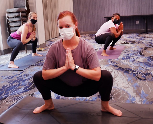 U.S. Air Force Maj. Chelsea Arnold, center, a clinical social worker and member of a behavioral health team, COVID Theater Hospital-1, Travis Air Force Base, Calif., teaches a yoga class to U.S. Air Force Capt. Bridget Caulkins, left, and U.S. Air...