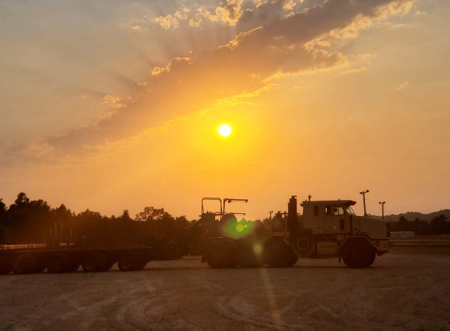 Military vehicles assigned to the 1158th Transportation Company of the Wisconsin National Guard are shown at sunset Aug. 26, 2020, at Fort McCoy, Wis. On Aug. 25, Soldiers with the 1158th unloaded 22 railcars at the installation's rail yard on...