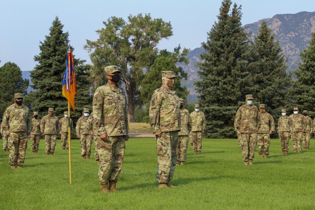 Col. Roger F. Deon, Jr., commander of the 11th Expeditionary Combat Aviation Brigade, and Command Sgt. Maj. Carl M. Sheckles, Jr., brigade senior enlisted noncommissioned officer, stand in front of a formation at Manhart Field on Fort Carson, Colo., Aug. 15, 2020, to recognize the Soldiers whose work significantly contributed to the success of Operation Crossbow.