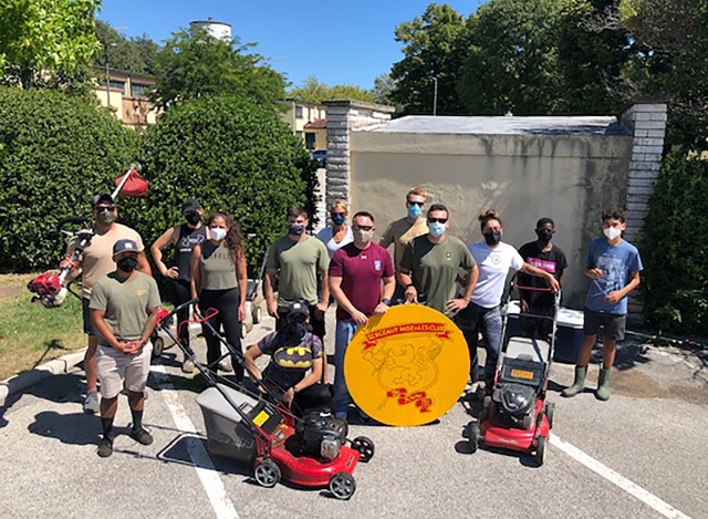 VICENZA - Approximately 15 volunteers, including members of the Vicenza Sergeant Morales Club, alongside members of Better Opportunities for Single Soldiers Program and Soldiers from a local Army Reserve unit pose for a picture after helping mow...