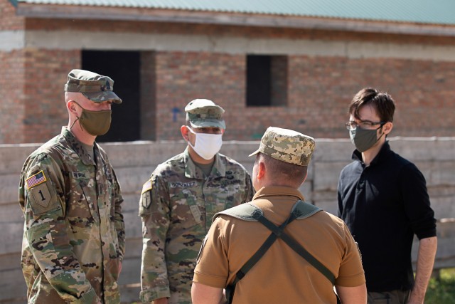 Brigade Training Group Officer and Non-Commissioned Officer in Charge, Maj. Lionel Gonzalez and Sgt. Maj. Michael Filipiak speak with Armed Forces Ukraine instructor, 1st Lt. Ihor Studenny during company-level training exercises, Aug. 26, at...