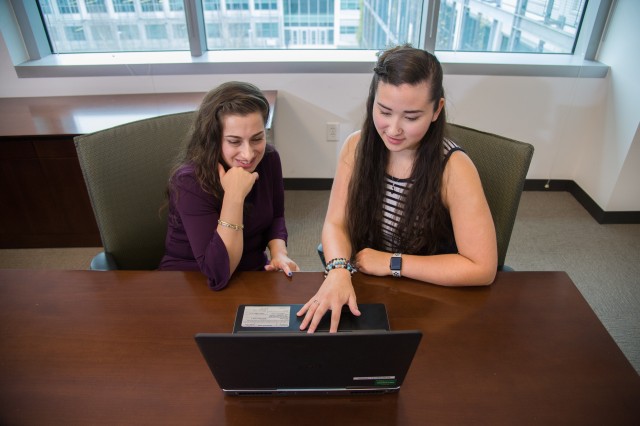 CECOM CDE program member Jacquelyn Riloff, left, a management and program analyst at CECOM’s Integrated Logistics Support Center, and CECOM CDE program member Kyra Gaskill, right, an information and arts tech writer/editor at ILSC, work together...