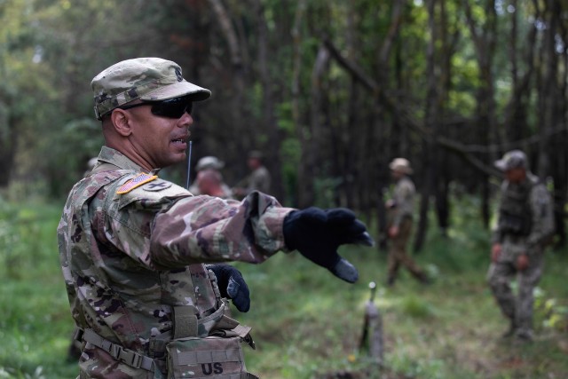 Sgt. 1st Class Theodore Durden oversees Armed Forces of Ukraine personnel as they practice detainee operations during company-level training exercises, Aug. 26, at Combat Training Center-Yavoriv, Ukraine.  (Photo by Cpl. Shaylin Quaid, JMTG-U...