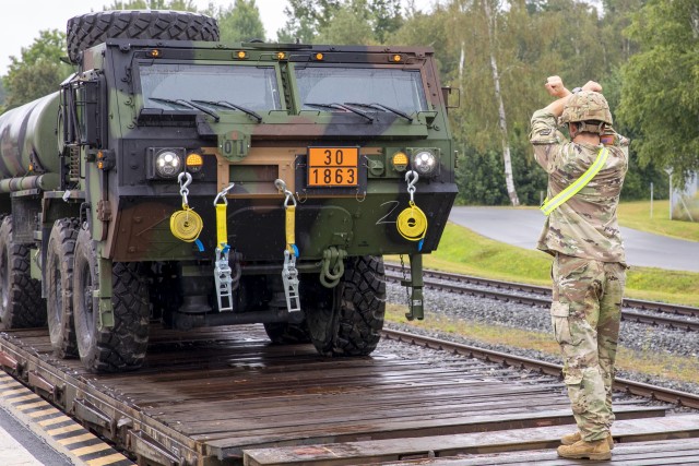 U.S. Soldiers, assigned to 1st Battalion, 6th Field Artillery Regiment, 41st Field Artillery Brigade, load trucks onto a train bound to Tapa, Estonia, for Rail Gunner Rush Aug. 19, 2020, in Grafenwohr, Germany. Rail Gunner Rush is the first live-fire exercise for the 41st FAB  outside of Grafenwoehr, Germany, since their reactivation in 2018. (U.S. Army photo bySpc. Ryan Barnes)