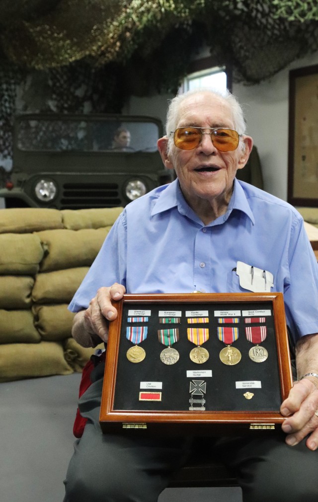 World War II veteran Donald Whitaker, who served in the Army from 1943 to 1946, holds a display case July 16, 2020, with the medals he earned during the war while visiting the Commemorative Area at Fort McCoy, Wis. Whitaker, of Elk Grove, Wis., and originally from DuPage County, Ill., made his first visit to Fort McCoy after having left 75 years earlier. When he left the Army, he was Technician Fifth Grade Donald Whitaker and was a bandsman with the 86th Infantry Division Band. Whitaker had served in the European theater of the war in Austria and Germany as well as the Pacific theater in the Philippines. He served for 2 1/2 years in various other support roles as well. (U.S. Army by Scott T. Sturkol, Public Affairs Office, Fort McCoy, Wis.)