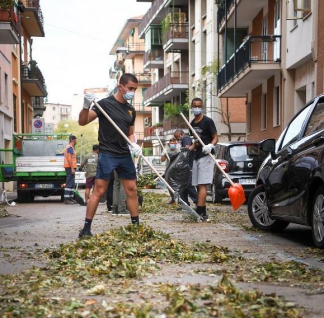 Soldiers from Dental Health Activity-Italy clean debris from the streets of Verona after a violent storm wreaked havoc on the city Aug. 23.