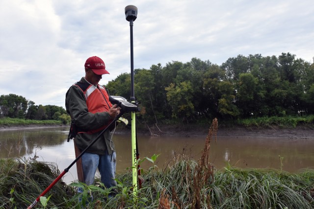 Paul Johnson, St. Paul District survey technician, uses his survey equipment to register a survey monument along the Red River of the North, near Georgetown, Minnesota, Aug. 12. The Corps of Engineers, St. Paul District, in partnership with the Rock Island and Omaha districts and the FM Diversion Authority, are placing monuments to get a better understanding of the environment within the region and to monitor for any potential impacts related to the construction and/or operation of the Fargo – Moorhead Metro Diversion Flood Risk Management Project.