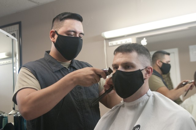 U.S. Army Reserve Sgt. Bryan Herrera trims the sides and behind the ears of a customer with an electric hair clipper at his Richmond, Va. store Aug. 18, 2020. Herrera balances a career as an Army Reserve NCO along with a full-time career as a barber and business owner. 