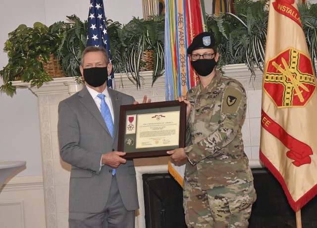 Vincent E. Grewatz, director, Installation Management Command-Training, presents Col. Hollie J. Martin with the Legion of Merit during an awards ceremony prior to her change of command event Aug. 7 at the Lee Club. Martin, the outgoing U.S. Army...