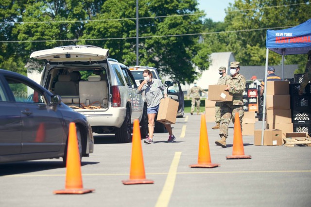 Volunteers including New York Army National Guard recruiters, local legislators and civilians, hand out produce and dairy during a drive through food distribution at Herkimer County Community College, Herkimer, N.Y., Aug. 26, 2020. Due to the...