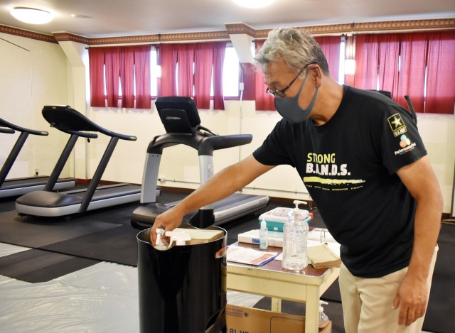 Mogi Kaoru, a maintenance handyman for Camp Zama’s Family and Morale, Welfare and Recreation, replaces a spray bottle containing bleach solution at the new site of the Sagami General Depot Gym on Sagami General Depot, Japan, Aug. 31.
