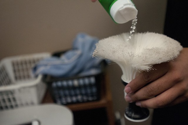 U.S. Army Sgt. Bryan Herrera powders a brush used to remove loose hairs from the back of a customer’s neck at his Richmond, Va. store Aug. 18, 2020. Herrera balances a career as an Army Reserve NCO along with a full-time career as a barber and...