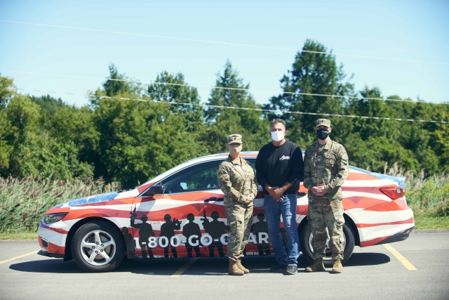 Sgt. 1st Class Jessica Girard, a recruiting and retention NCO, Robert Schrader, District 3 legislator, Herkimer County and Sgt. Steven Ludwig, a recruiting and retention NCO, hand out produce and dairy during a drive through food distribution at...