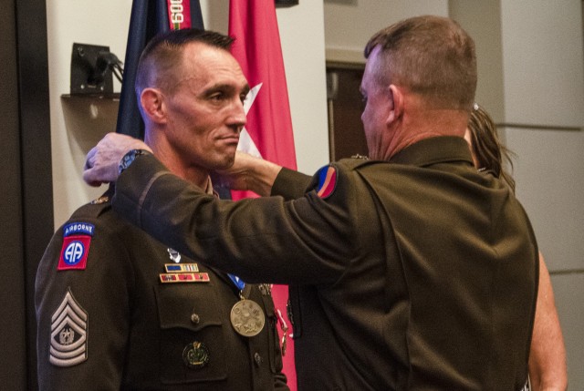 Gen. Paul E. Funk II, commanding general U.S. Army Training and Doctrine Command (right) presents Command Sgt. Maj. Timothy A. Guden (Ret.), with the General Brehon B. Somervell Medal at his retirement ceremony Sept. 3, 2020, Fort Eustis,...