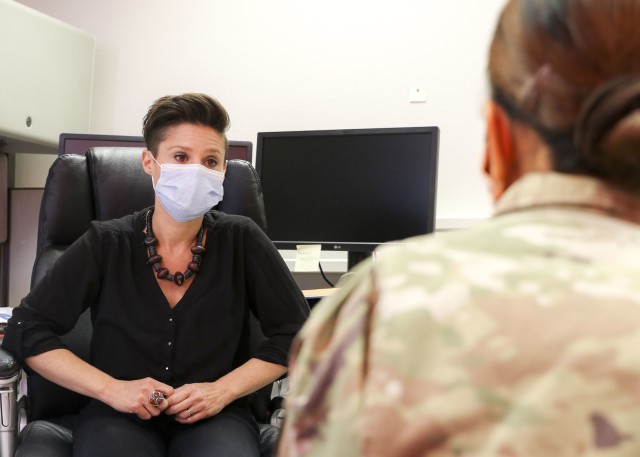 Dr. Jamie Moore, chief, Behavioral Health Division, Wiesbaden Army Health Clinic, dons a protective face mask while talking with a patient at WAHC, June 15. Moore believes military training and lifestyles have prepared military personnel for the shift from face-to-face relations to virtual interactions caused by responses to COVID-19 earlier this year.