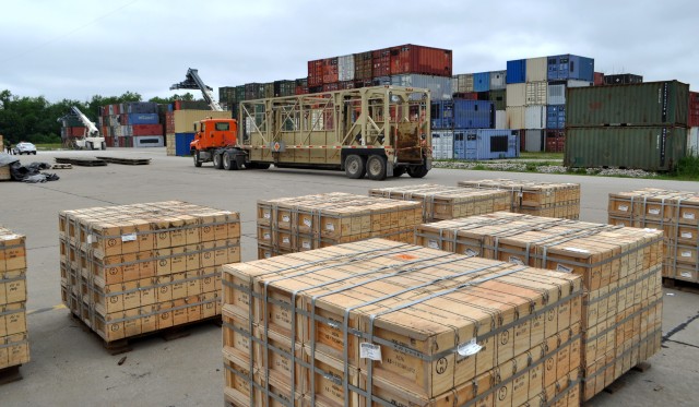 Ammo boxes await final placement in container on BGAD&#39;s primary out-loading platform.