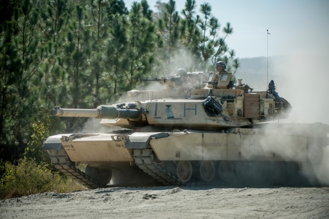 FORT BENNING, Ga. – In an October 2016 photo, an Abrams tank rolls forward as students from the Infantry and Armor Basic Leader courses hone their combat skills during a combined competitive maneuver exercise at Fort Benning. How to make the...