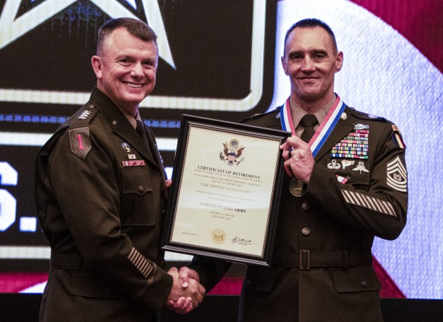 Command Sgt. Maj. Timothy A. Guden (Ret.and Right), previous command sergeant major, U.S. Army Training and Doctrine Command, is presented with his official retirement certificate from Gen. Paul E. Funk II, commanding general TRADOC, at his...