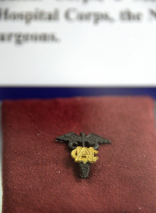 This Army Nurse Corps pin is one of the items related to Army medicine currently on display at Munson Army Health Center. Two display cases with memorabilia from the Frontier Army Museum are on long-term exhibit at MAHC. Photo by Prudence...