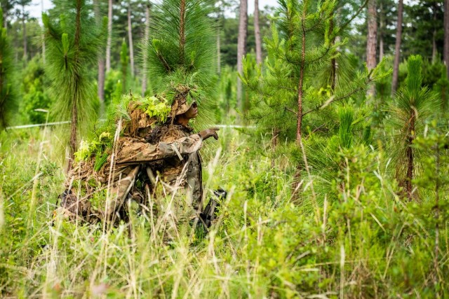In a June 2020 photo, a Soldier enrolled in the U.S. Army Sniper Course at Fort Benning gets guidance from an instructor about which way to move next as the Soldier learns how to stalk targets. How to make the Army's Infantry and Armor forces...