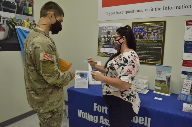 Betty Guthrie, Fort Campbell installation voting assistance officer, provides Pvt. Kyle Loche, 2nd Brigade Combat Team, 101st Airborne Division (Air Assault), with voting registration information, Aug. 25, at Soldier Support Center, 2702 Michigan Ave. Fort Campbell, Ky.