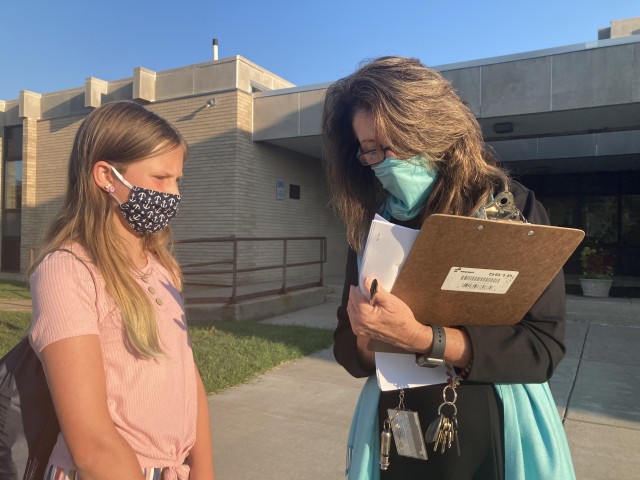 On the first day of school Aug. 24, Mahaffey Middle School Principal Linda Haberman greeted students including Sophia Arntson, sixth grade, as they approached the school. About 385 students returned to in-person classes at the middle school on Fort Campbell, Ky.