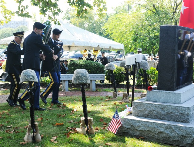 Retired Maj. Gen. George E. Barker directs the laying of the wreath