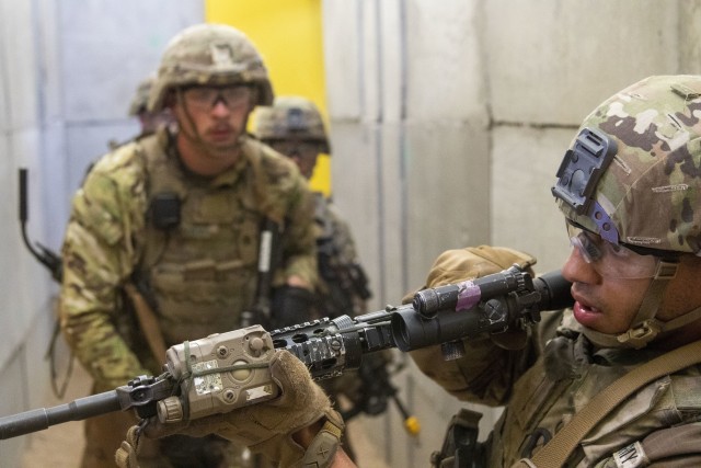 Pfc. Brian Mafuz checks for hostile threats in a shoot house hallway before his squad advances, August 6, 2020 at Fort Drum, N.Y. Soldiers from C Co., 2nd Battalion 14th Infantry Regiment, 2nd Brigade Combat Team, 10th Mountain Division (LI) conducted a multi-day training exercise emphasizing squad-level tasks. (U.S. Army photo by Pfc. Josue Patricio)